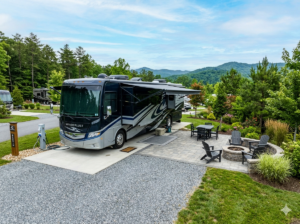 Back-in premium RV site at Loveland RV Resort with a patio, fire pit, full hookups, and mountain views.