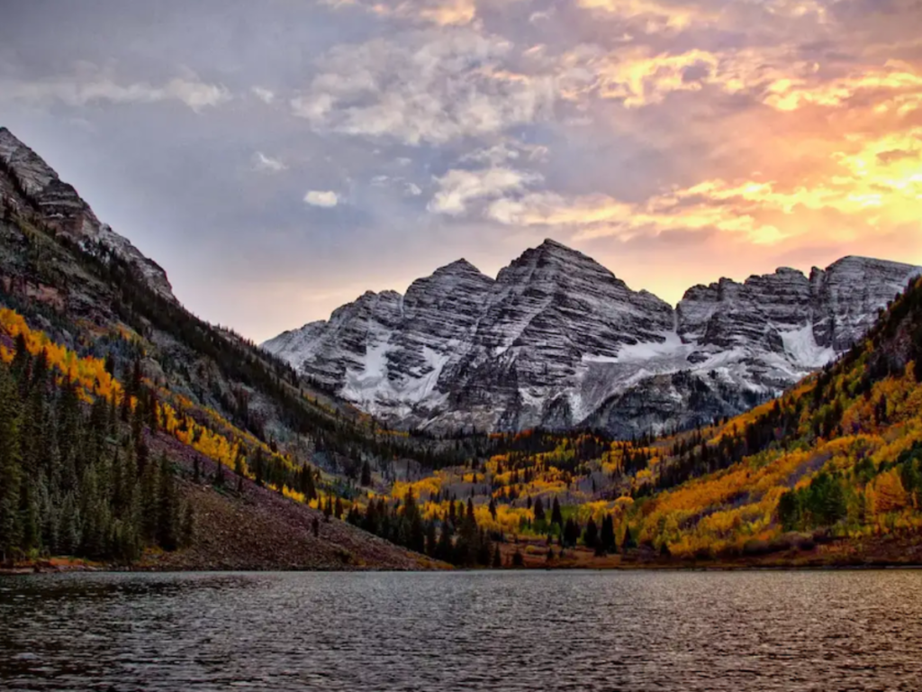 Maroon Bells at sunrise with a mountain lake and fall foliage near Northern Colorado RV resorts.