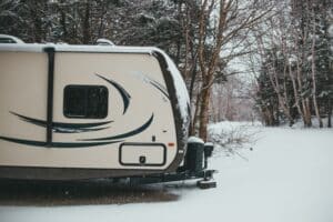 Travel trailer parked in winter snow
